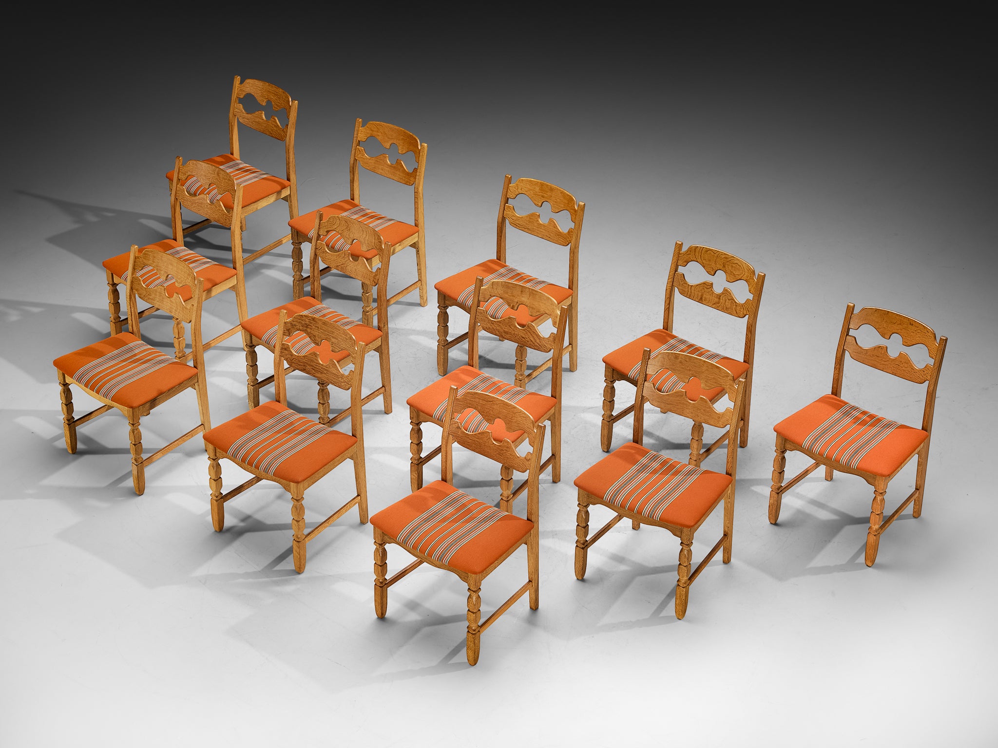 Henning Kjærnulf for Nyrup Møbelfabrik Set of Twelve Carved Dining Chairs in Solid Oak