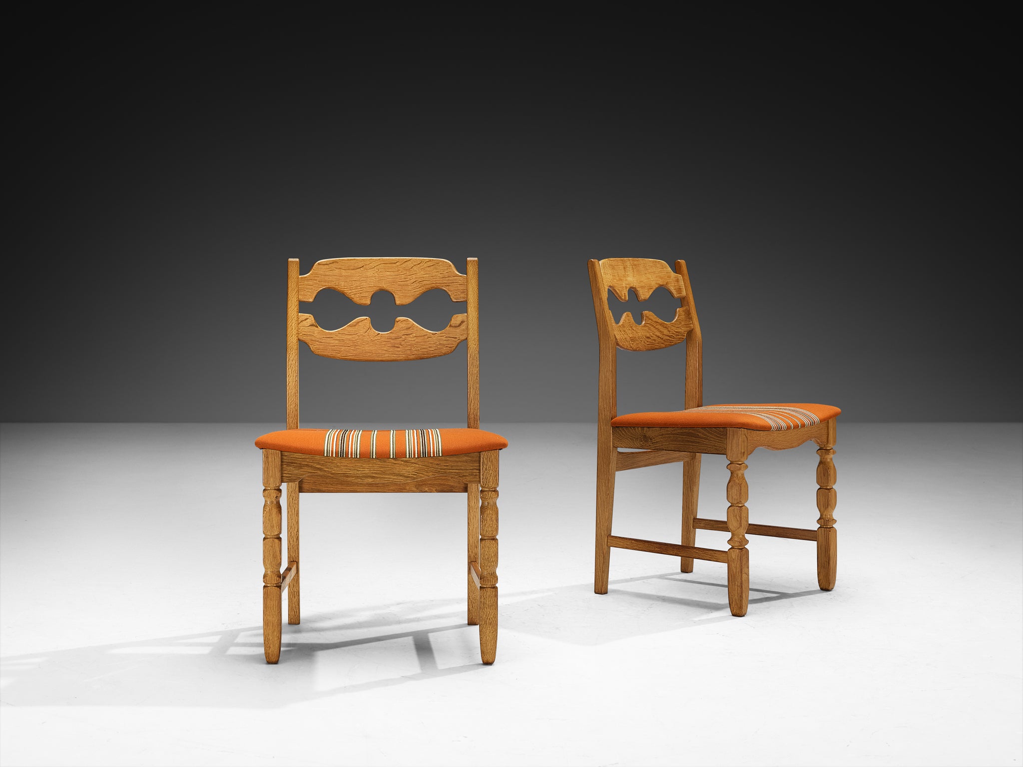 Henning Kjærnulf for Nyrup Møbelfabrik Set of Twelve Carved Dining Chairs in Solid Oak