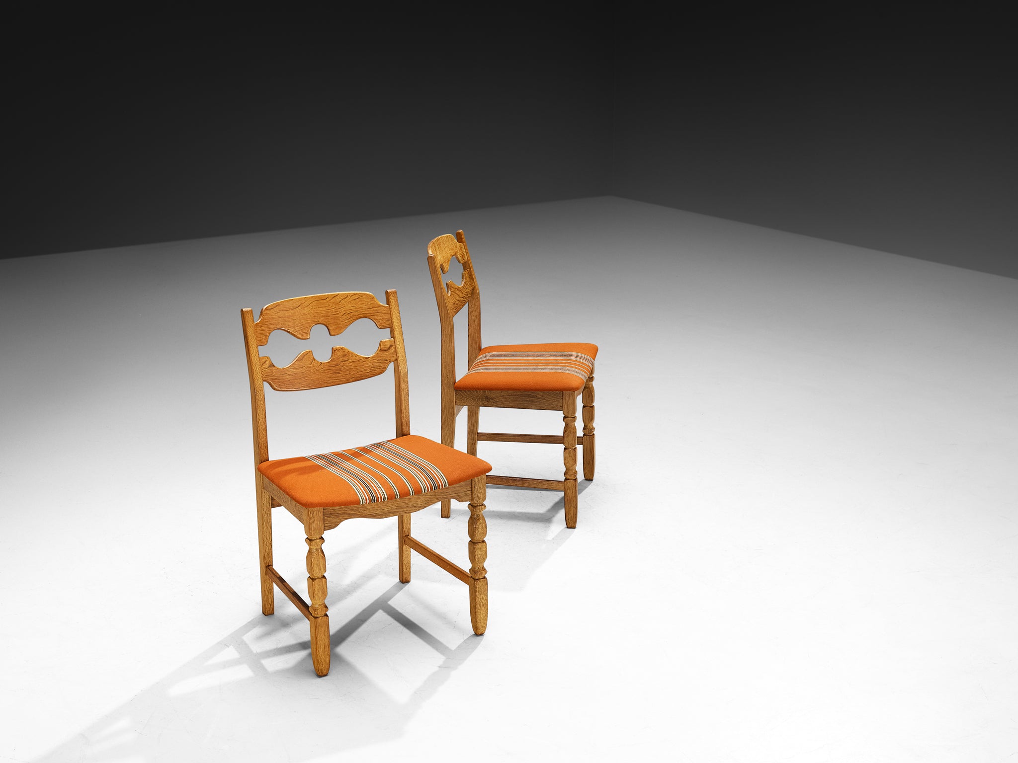 Henning Kjærnulf for Nyrup Møbelfabrik Set of Twelve Carved Dining Chairs in Solid Oak