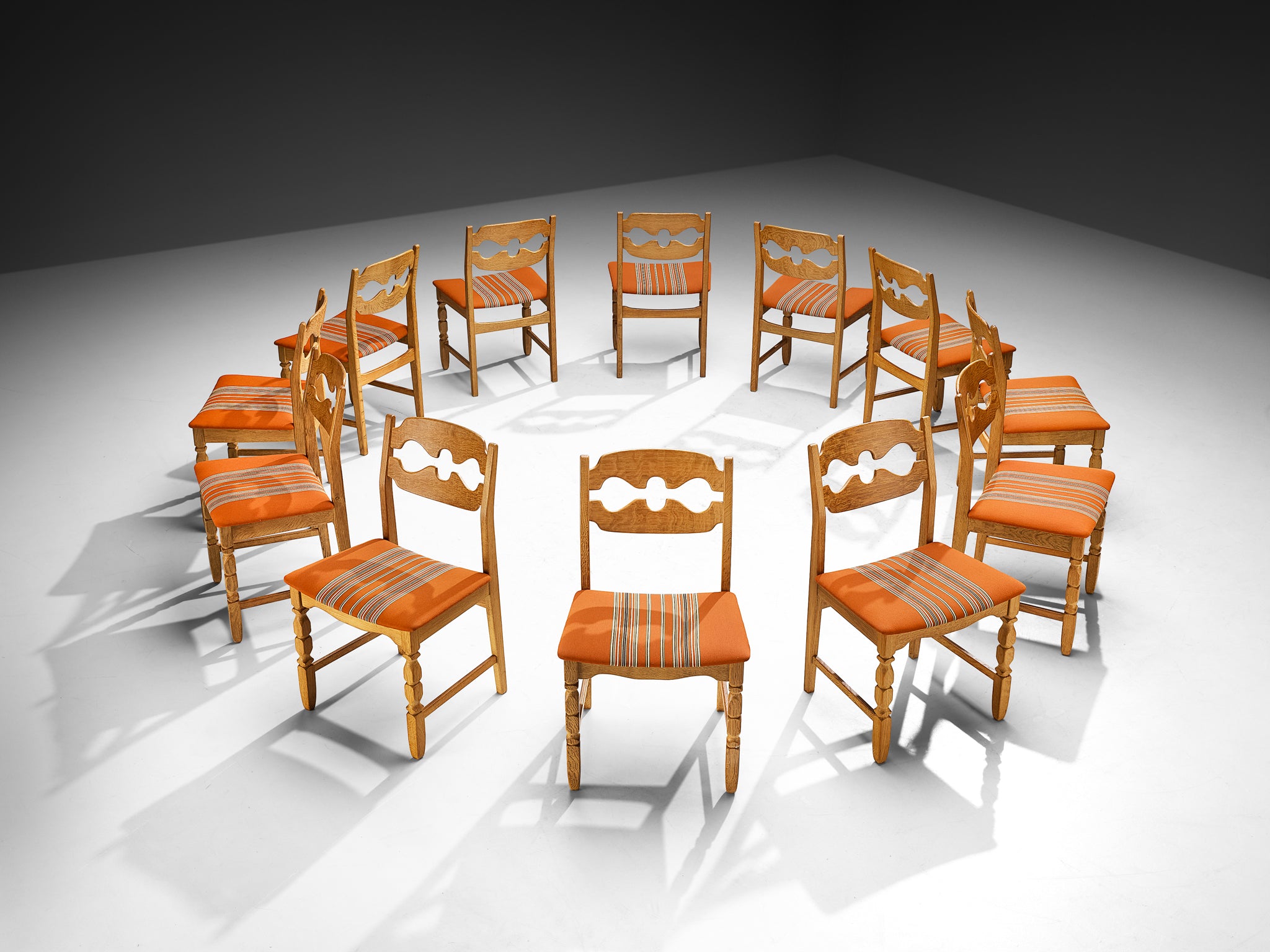 Henning Kjærnulf for Nyrup Møbelfabrik Set of Twelve Carved Dining Chairs in Solid Oak