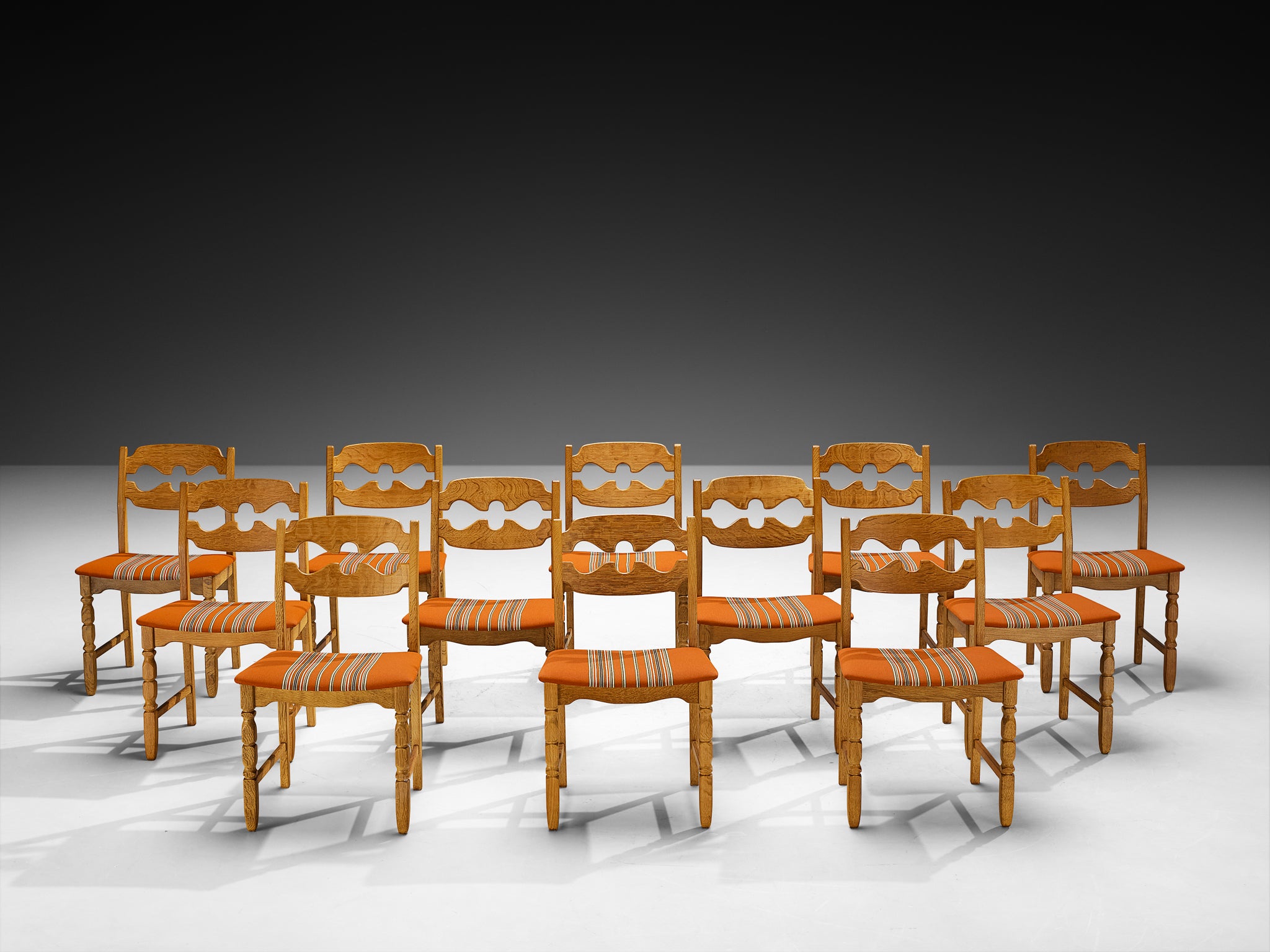 Henning Kjærnulf for Nyrup Møbelfabrik Set of Twelve Carved Dining Chairs in Solid Oak