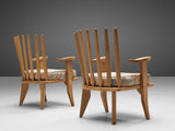 Guillerme & Chambron Pair of Lounge Chairs and Footstools in Oak